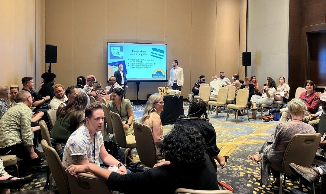 the photo shows the center of a restorative dialogue circle that is often a format used for training and discussion. Many restorative values, books, and sentimental objects of significance fill the colorful center to help ground participants during circle.